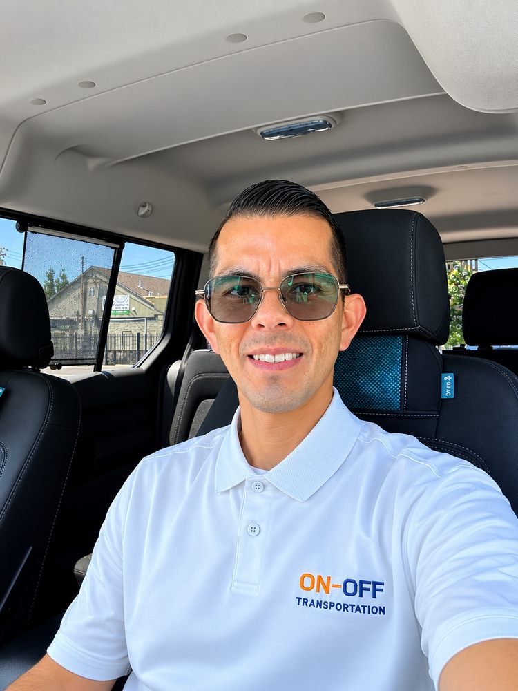 On-Off Transportation driver wearing a white branded polo shirt