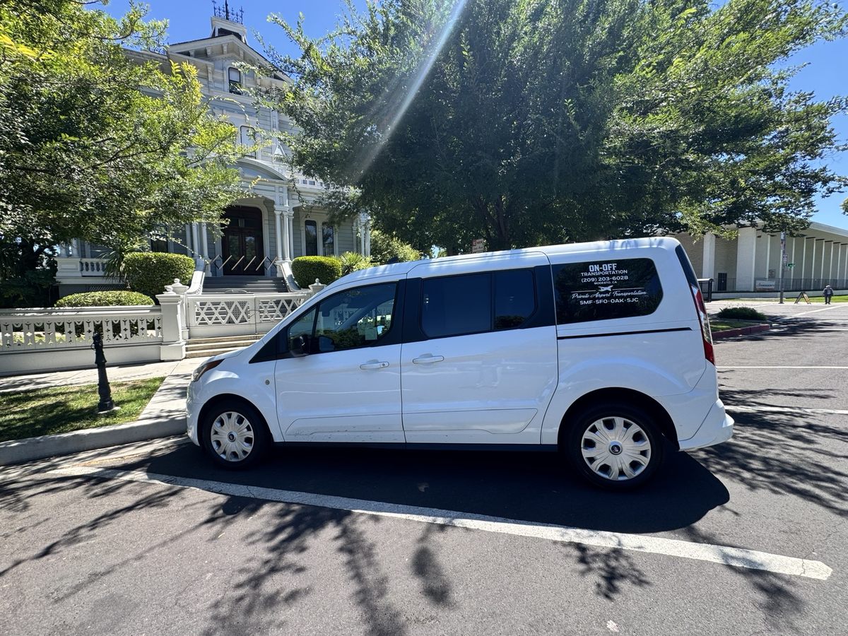 White On-Off Transportation passenger van photographed from the side
